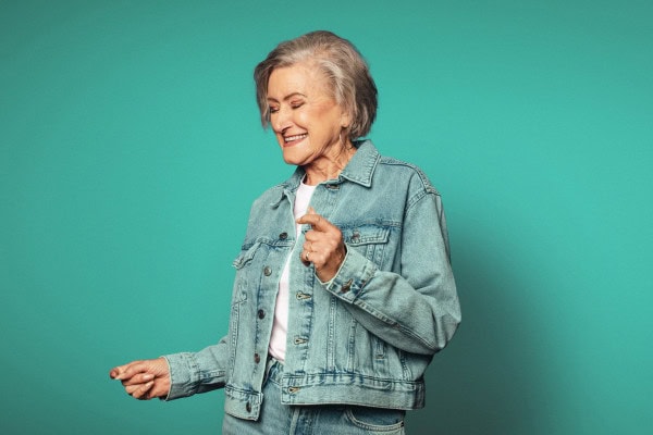 A lady smiling and happy dancing.